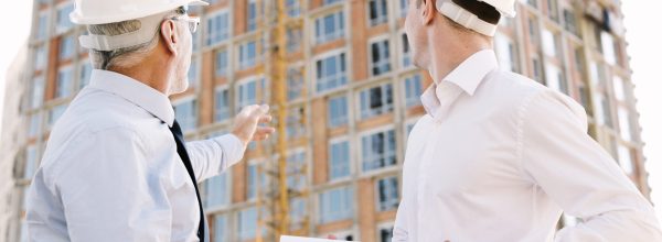 low-angle-people-with-helmets-looking-scaffolding-design